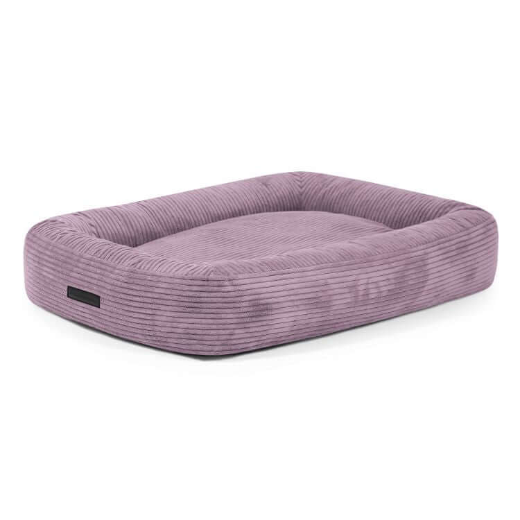 Cama para perro de terciopelo acanalado DOG BED 100 WAVES (100×70×20 cm), color lavanda, con bordes elevados y superficie plana para dormir, sobre fondo blanco.