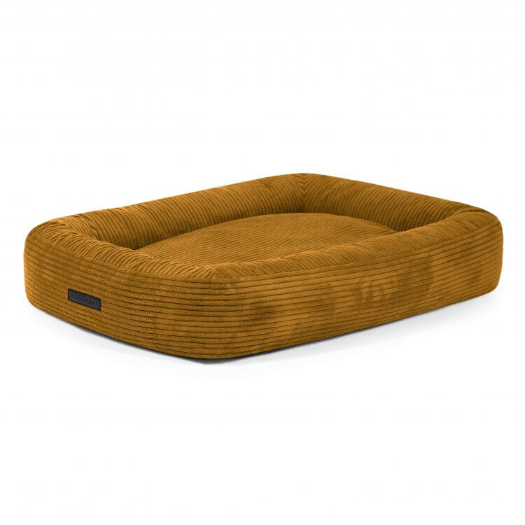 Cama para perro DOG BED 100 WAVES de terciopelo acanalado (100×70×20 cm), color marrón y bordes elevados, exhibida sobre un fondo blanco.