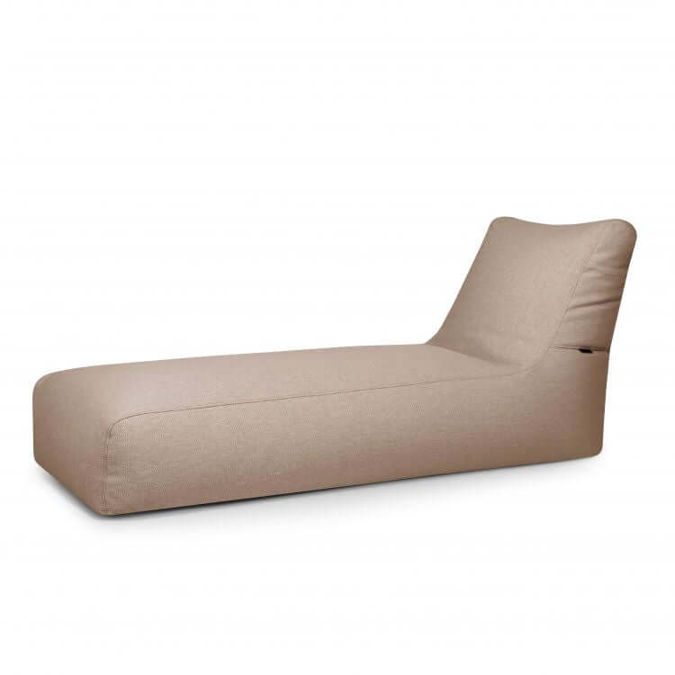 La tumbona Bean Bag Sunbed Dunes - uso exterior es una moderna tumbona beige con base rectangular baja y respaldo reclinado, inspirada en la relajada comodidad de las tumbonas Bean Bag, que se muestra sobre un fondo blanco liso.
