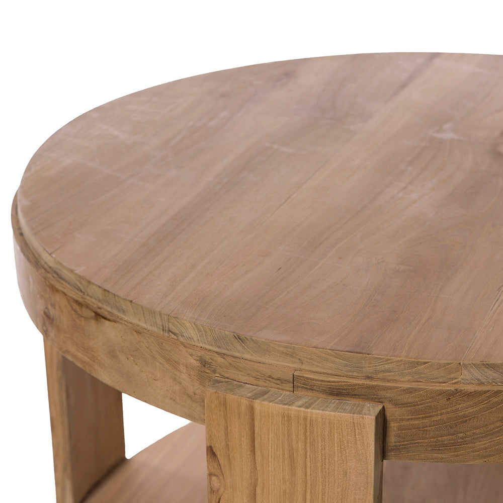 La Mesa de centro redonda en madera de teca Nabila Ø80 es una mesa redonda de madera con acabado natural, que presenta una superficie lisa y patas robustas que encarnan el diseño minimalista.