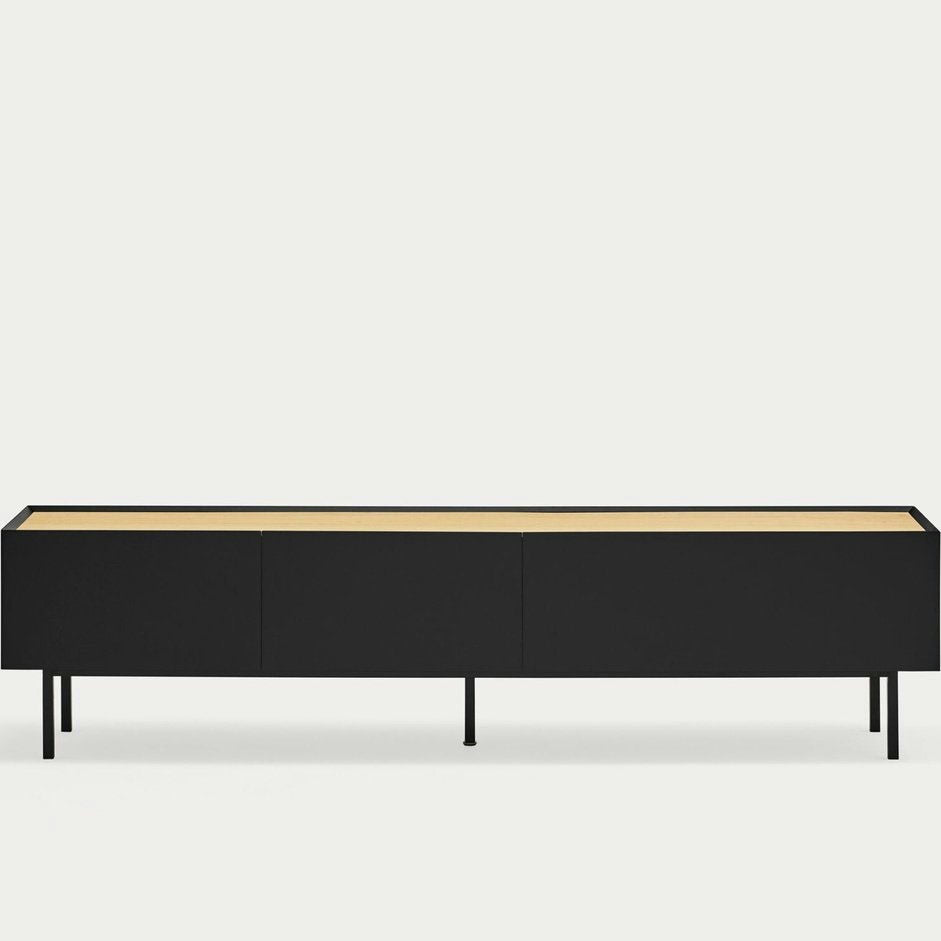 El Mueble TV Arista 1P2C es un aparador minimalista negro con tres compartimentos sobre patas delgadas y una superficie de madera clara que encarna el diseño moderno. Es perfecto para quienes buscan un almacenamiento sofisticado en su espacio vital.