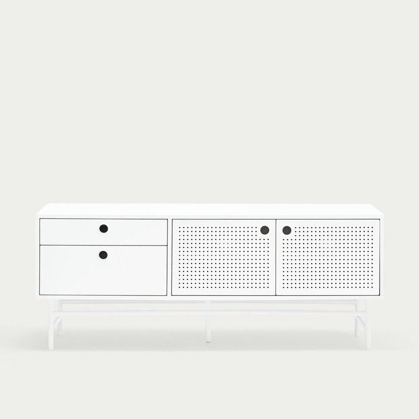 El Mueble TV Punto 2P2C, un aparador blanco con dos cajones y puertas de armario perforadas, presenta tiradores redondos negros y se destaca sobre un fondo claro y liso. Es el almacenamiento elegante perfecto con un diseño moderno para cualquier habitación.