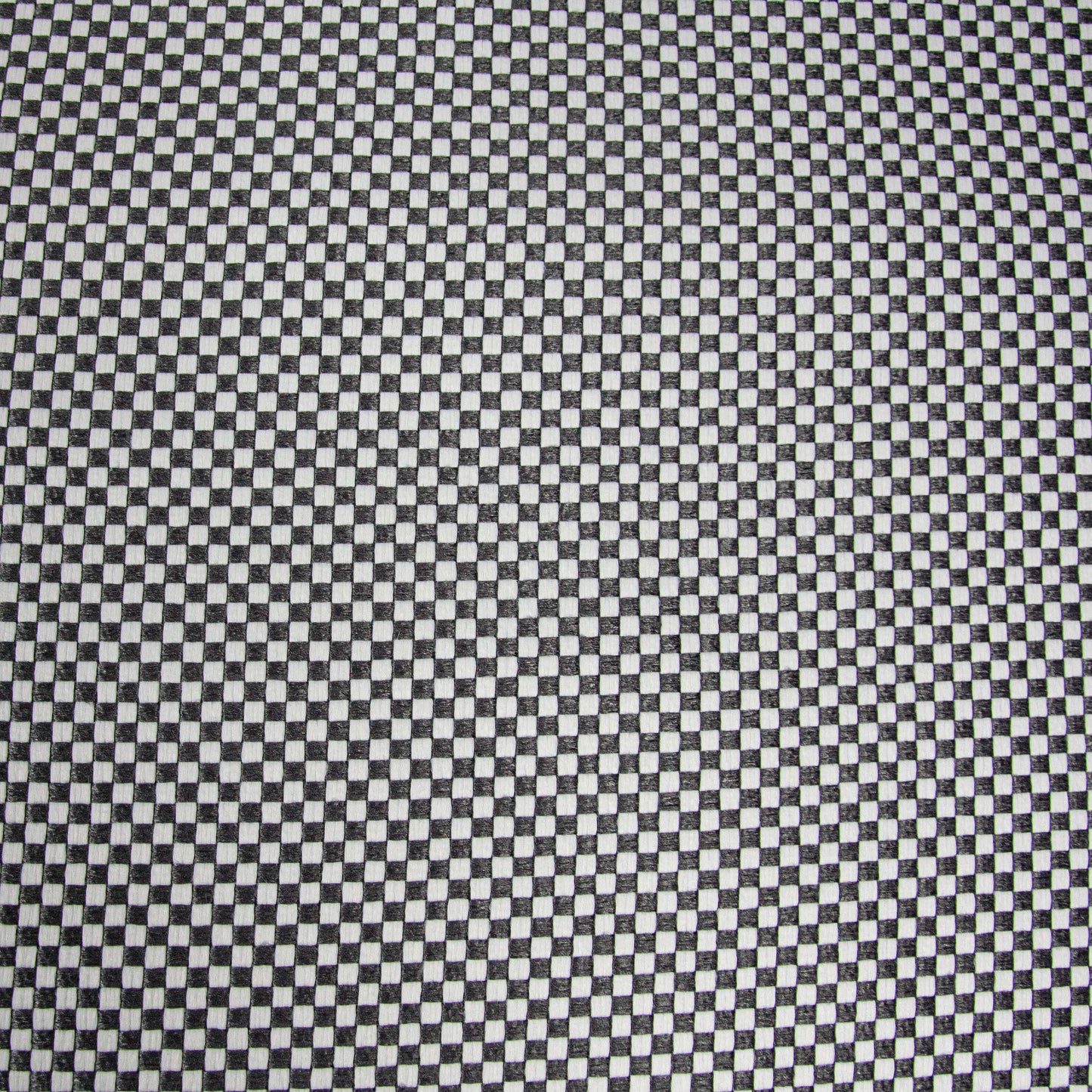 Detalle de una tela tejida a cuadros blancos y negros, con pequeños cuadrados alternados en una cuadrícula repetitiva, ideal para tapizar el Foam Bean Bag OM 110 Capri - uso exteriores.