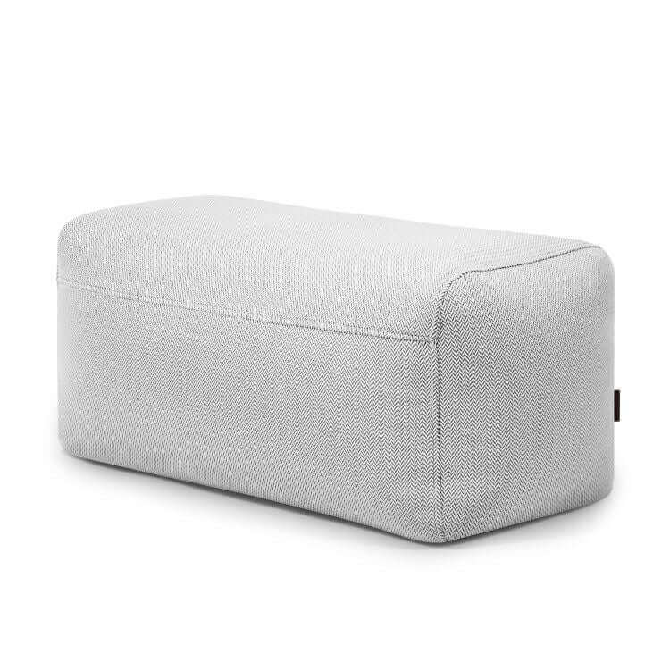 El Pouf Plus 100 Canaria es un puf rectangular de tela gris con bordes redondeados, perfecto como puf exterior o asiento para jardín, mostrado sobre fondo blanco.