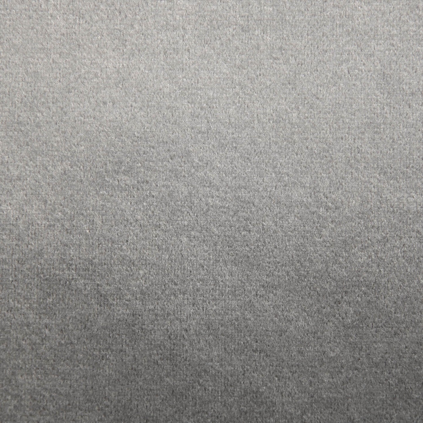 Un primer plano de un tejido liso de textura gris, uniformemente iluminado y sin marcas, ideal para el Puff gigante redondo de terciopelo 135×135×50 cm - moderno - salón - ROLL 135 BARCELONA.