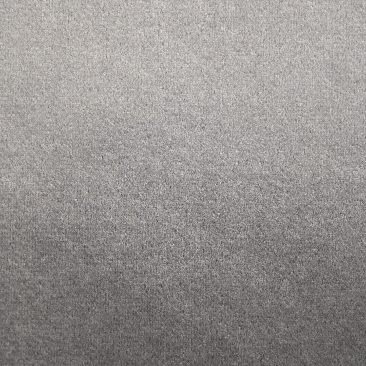 Un primer plano de una superficie de tela gris texturizada, similar a la comodidad de felpa del ChatGPT Plus Puff de foam tapizado en terciopelo 85×68×40 cm - moderno - salón, dormitorio - SNUG 83 BARCELONA.