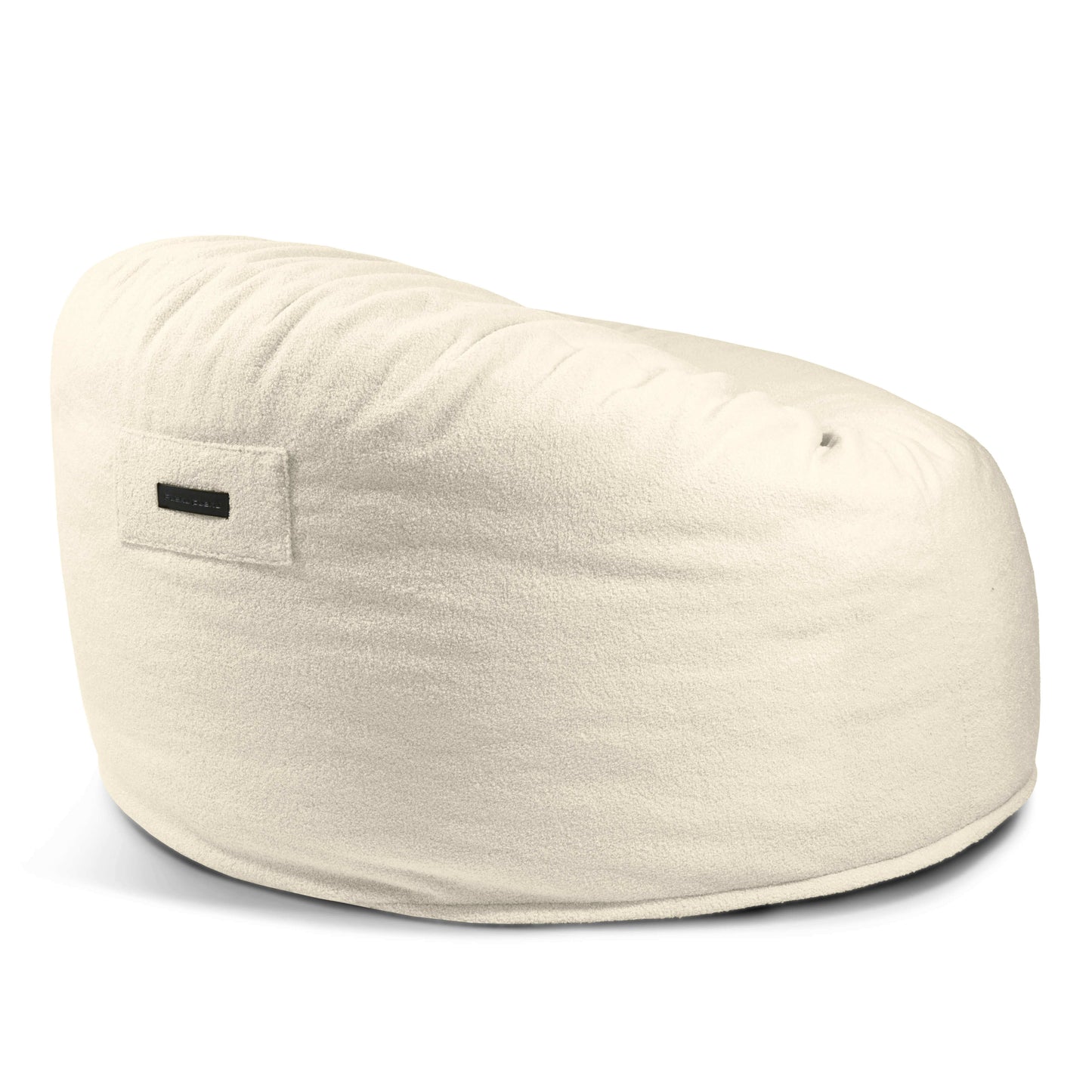 Un gran Foam Bean Bag OM 110 Barcelona de color blanco roto con una suave funda de tejido Teddy y una pequeña etiqueta rectangular en el lateral.