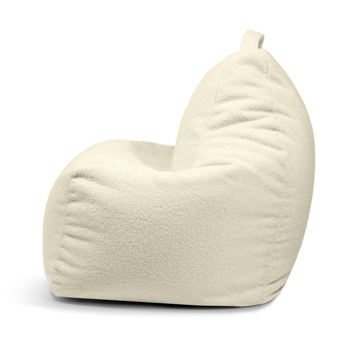 Vista lateral del Bean bag Play Teddy en tejido beige claro con una textura suave y afelpada y una pequeña asa superior: perfecto como puff de diseño moderno para espacios acogedores.