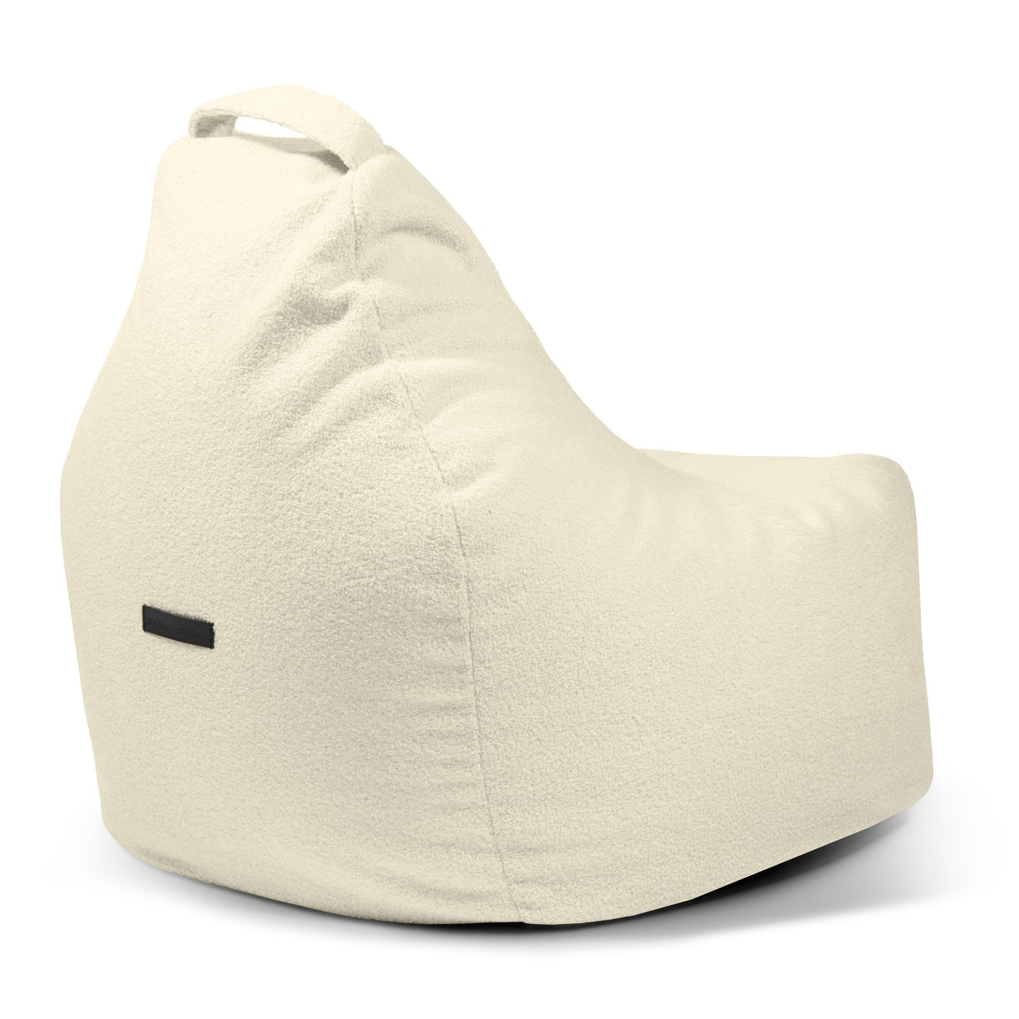La Bean bag Play Teddy es una moderna silla beige claro para niños con un asa en el respaldo y una pequeña etiqueta rectangular negra en el lateral, que se muestra sobre un fondo blanco.