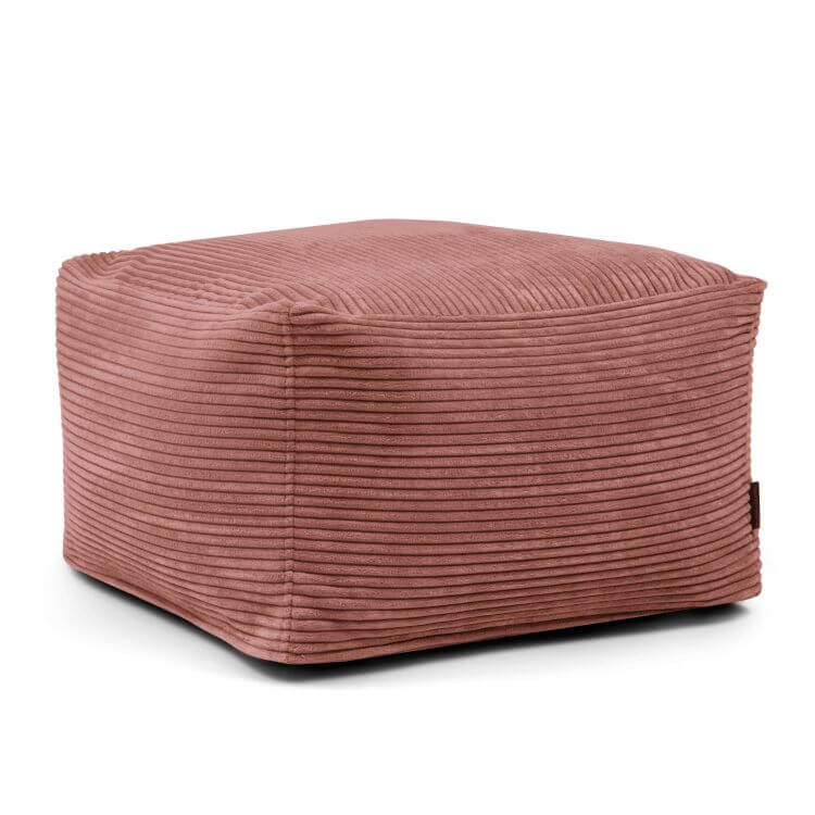 Se muestra una otomana cuadrada de pana lavable (70×70×40 cm) en color malva de SOFTBOX WAVES colocada sobre un fondo blanco, ideal para el salón o el dormitorio.
