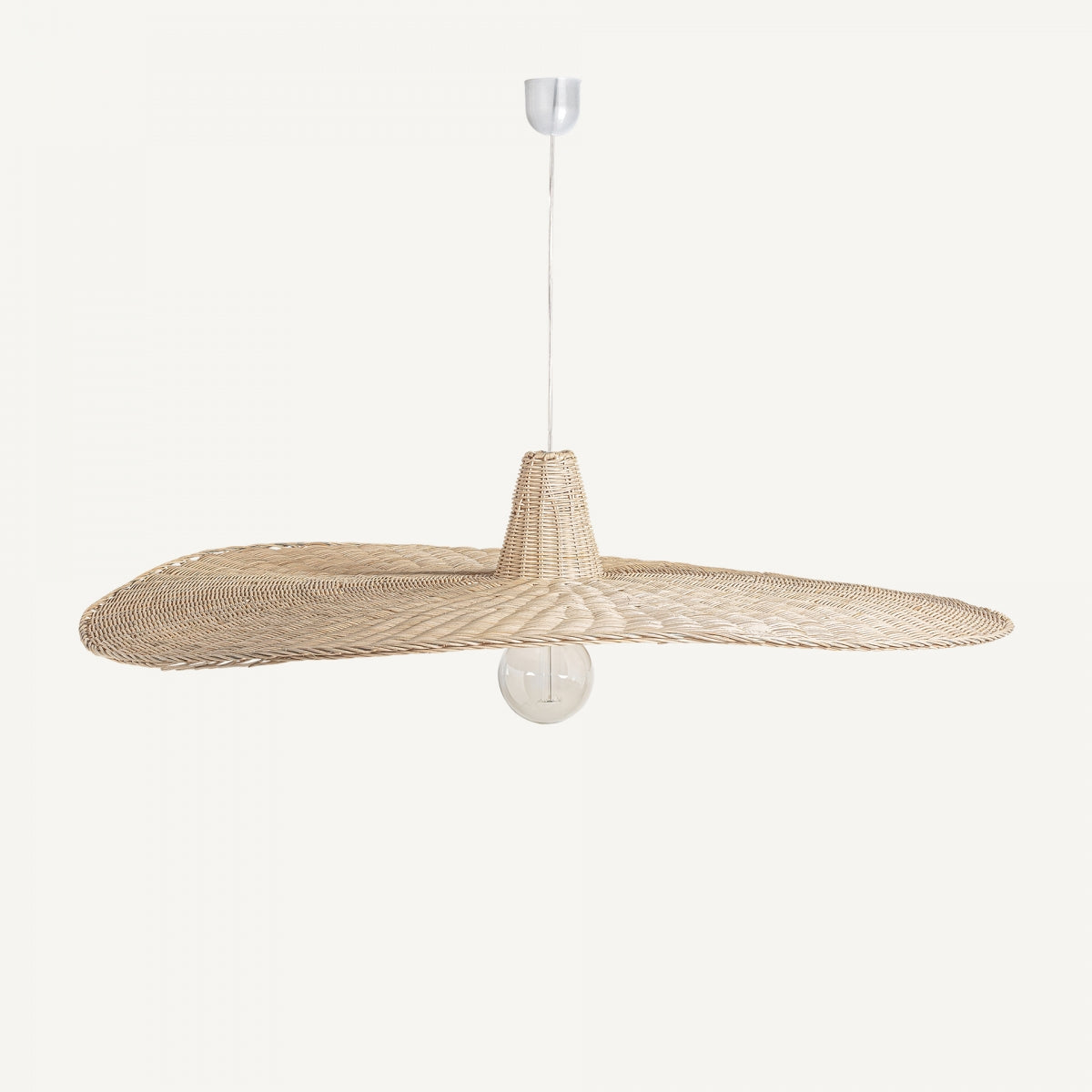La lámpara colgante en ratán Uxmal S es de estilo boho chic, hecha en ratán marrón tejido con pantalla ancha y plana, bombilla visible y cable blanco, perfecta para ambientes modernos y naturales.