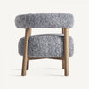 El sillón tapizado y madera de fresno Allitz presenta tapizado de bouclé gris, un respaldo redondeado y no tiene apoyabrazos para mayor comodidad en su elegante diseño contemporáneo, todo ello elegantemente sostenido por patas de madera.