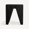 El Taburete bajo en madera reciclada negra Bruschal luce un diseño angular sobre un fondo blanco liso, combinando a la perfección estilo y funcionalidad.