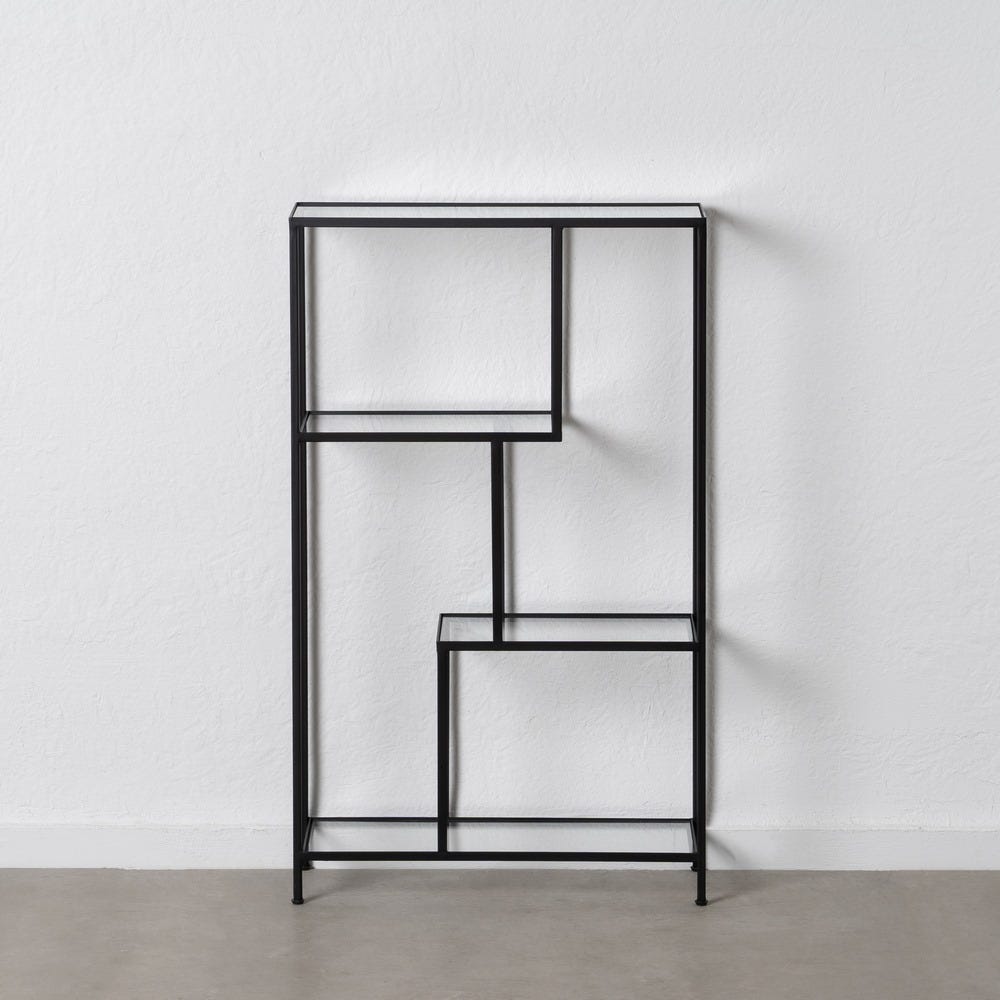 La Estantería Moderna Pequeña en Metal y Cristal Square es una estantería geométrica de metal negro que captura el diseño industrial, colocada con estilo contra una pared blanca lisa sobre un piso gris.