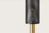 Primer plano de un micrófono negro con rejilla metálica perforada y sección inferior dorada, diseño texturizado, aislado sobre fondo blanco.