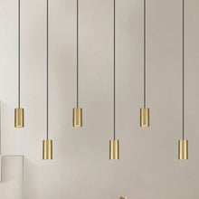  La pared beige está acentuada por seis Lámparas de Techo Colgantes Dorado 3043-1C, que ofrecen un toque perfecto de iluminación moderna.