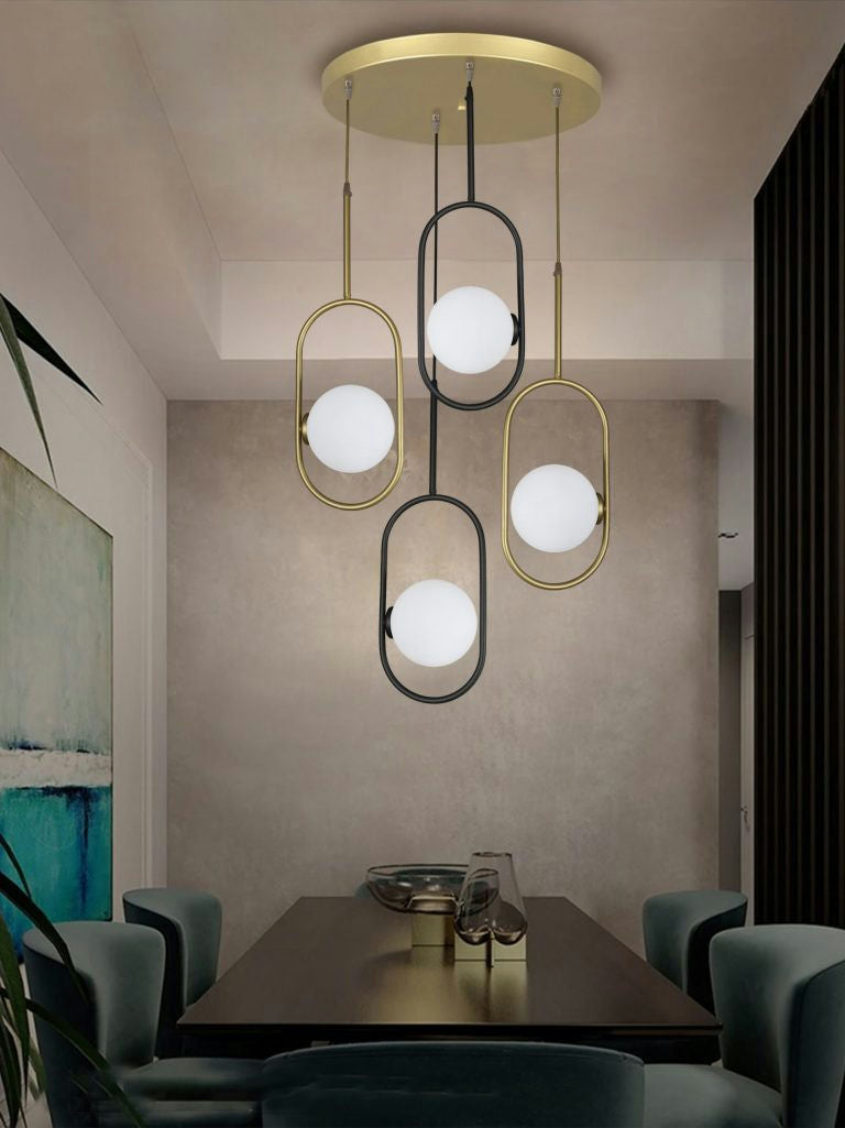Un comedor moderno presenta un diseño contemporáneo con la Lámpara de Techo Colgante Industrial 3135-4C sobre la mesa, rodeada de sillas verdes. Un cuadro y una planta se suman al ambiente elegante.