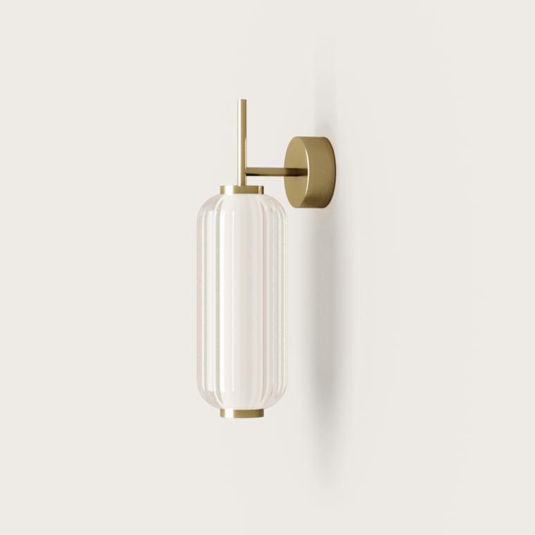 La Lámpara de pared Elma combina una pantalla de vidrio cilíndrica con detalles metálicos en tonos dorados, mostrando diseño contemporáneo y brindando iluminación LED ecológica.