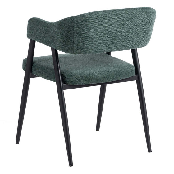 Una silla tapizada en tela verde con patas de metal negro, vista desde atrás. La Silla Verde Tejido-Metal Salón 56 x 60 x 81 cm cuenta con un respaldo curvo, un asiento acolchado y resistentes patas de acero para una mayor durabilidad.