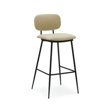  El Taburete Alto en Metal y Tapizado Cushi es un taburete alto de color beige con asiento y respaldo acolchados, que presenta un elegante diseño ergonómico sostenido por elegantes patas de metal negro.