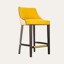  Un taburete de bar moderno, el **Taburete en Madera y Tapizado Xally**, con asiento y respaldo acolchados de color amarillo, respaldo beige y patas de madera oscura, colocados sobre un fondo liso. Este taburete de diseño contemporáneo en madera ofrece estilo y comodidad para cualquier entorno.