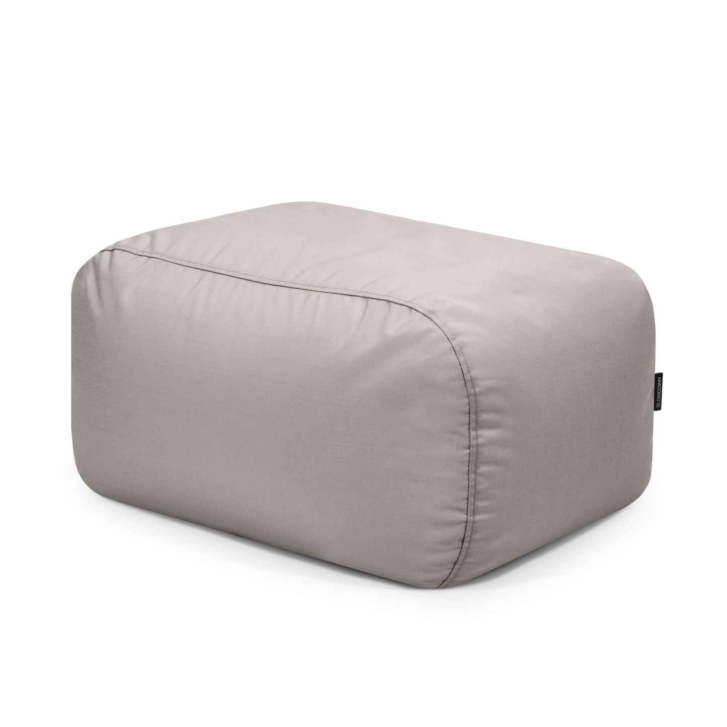 El Bean bag Tube Pouf Colorin, diseñado para uso exterior, es un puf rectangular de tela gris claro con bordes redondeados y un acabado resistente al sol que se muestra sobre un fondo blanco liso.