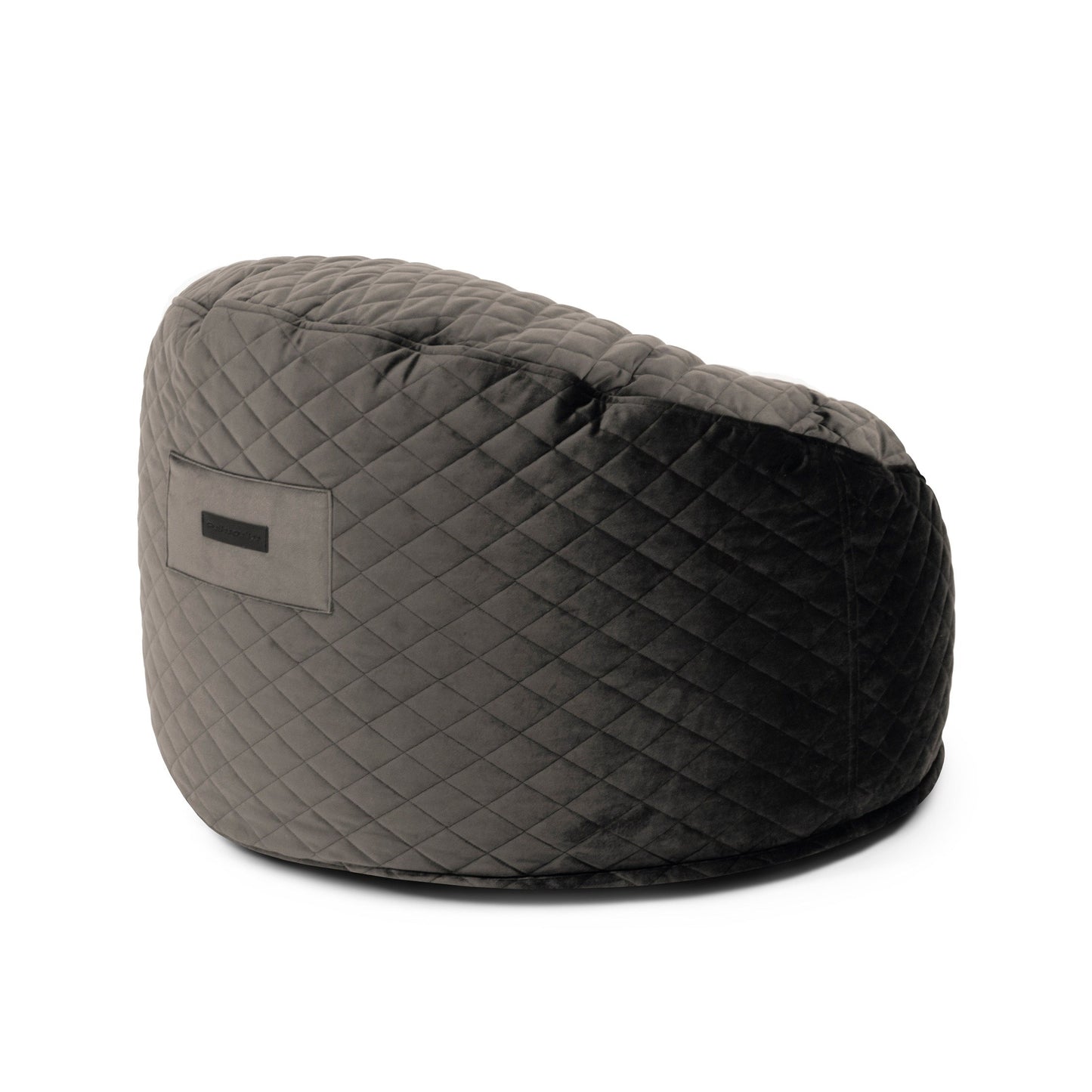 Un elegante puff gris oscuro redondo de foam y terciopelo acolchado 85×85×38 cm (OM 85 LURE LUXE) para salón o dormitorio, con etiqueta lateral, diseñado como un elegante asiento infantil, mostrado sobre fondo blanco.