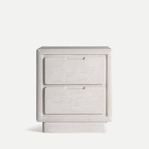 La mesita de noche en DM blanco Comodino Arnsberg muestra su diseño minimalista de dos cajones en colores claros sobre un fondo liso, personificando la elegancia y la simplicidad modernas con su estética en bloques.
