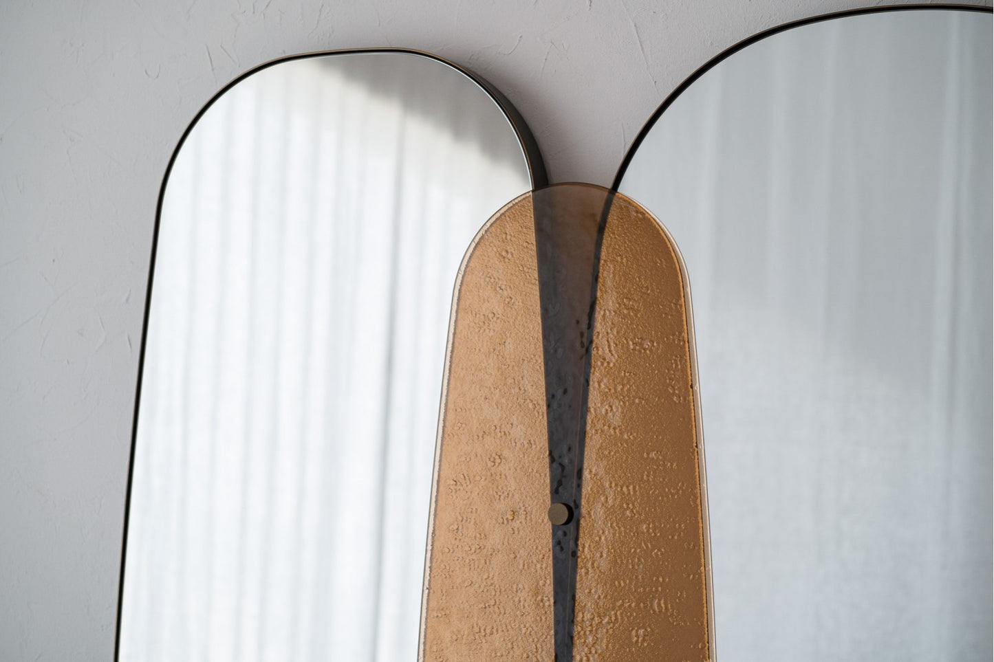 Tres Espejos de pie contemporáneos con vidrio ámbar y marco de metal en oro envejecido (180×5×118 cm) se disponen contra una pared clara; uno de ellos presenta un panel beige texturado en el centro.