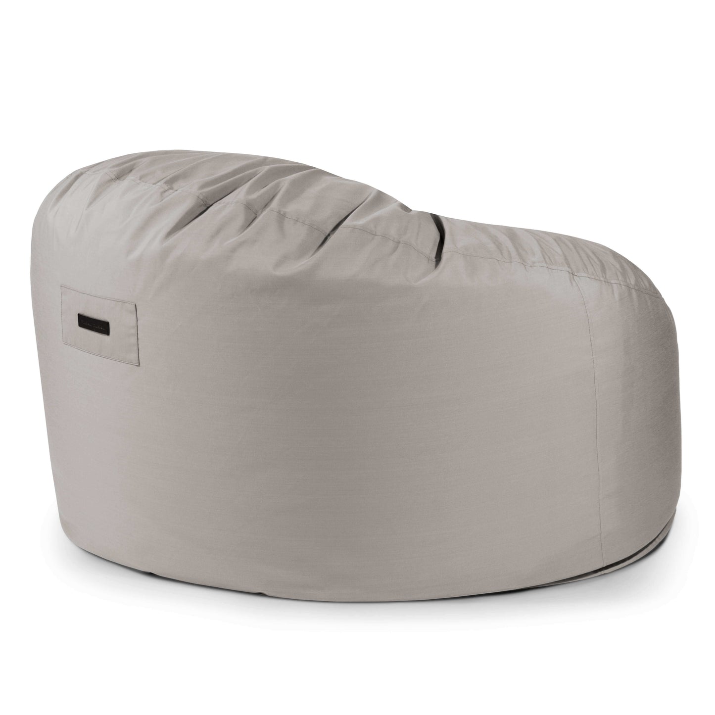 El Foam Bean Bag OM 110 Barcelona en gris claro presenta un respaldo redondeado, una pequeña etiqueta lateral y ofrece soporte ergonómico, mostrado sobre un fondo blanco.