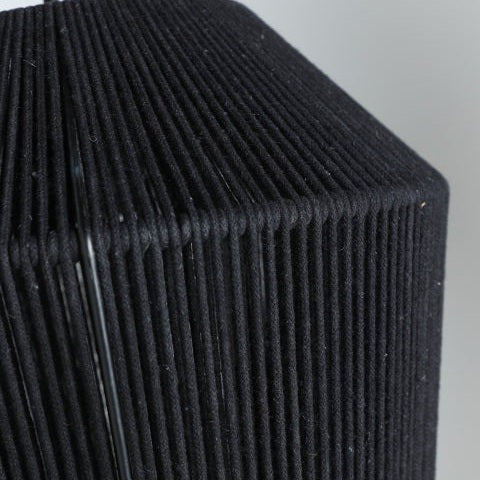 Primer plano de la Lámpara de techo en algodón y hierro Sayil, mostrando su superficie negra texturizada con crestas verticales espaciadas uniformemente y un borde afilado en ángulo recto que acentúa su diseño geométrico.