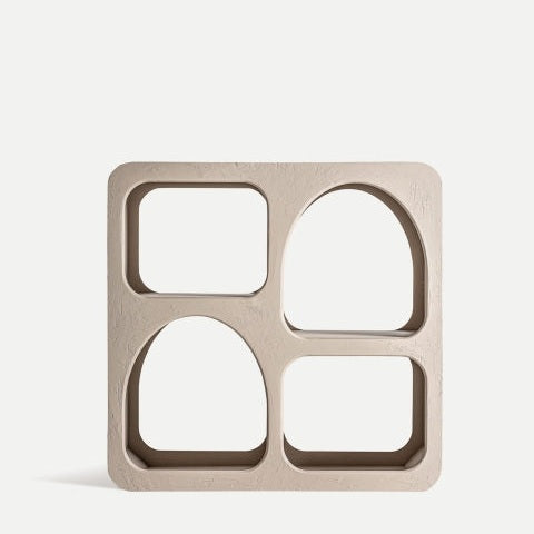 El Estante en madera de mango Kotka, cuadrado y beige, tiene cuatro compartimentos con formas rectangulares redondeadas y arcos. Su diseño minimalista resalta la durabilidad y el estilo sobre un fondo claro.