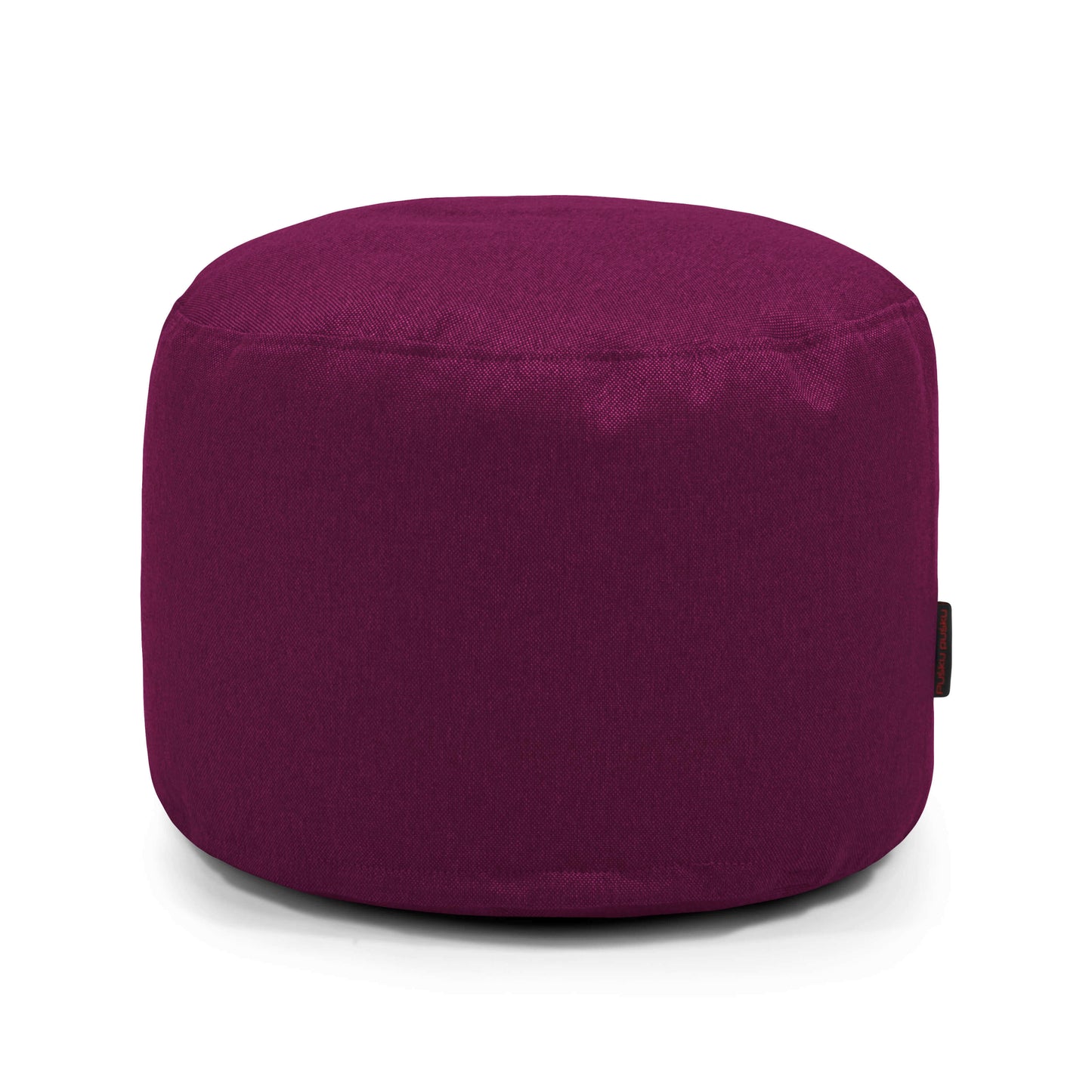 Un puf redondo y compacto de color morado (MINI NORDIC, 40×40×30 cm) fabricado en suave tejido lavable con lados lisos y parte superior plana, ideal como asiento versátil para espacios pequeños en dormitorios o salones, sobre fondo blanco.