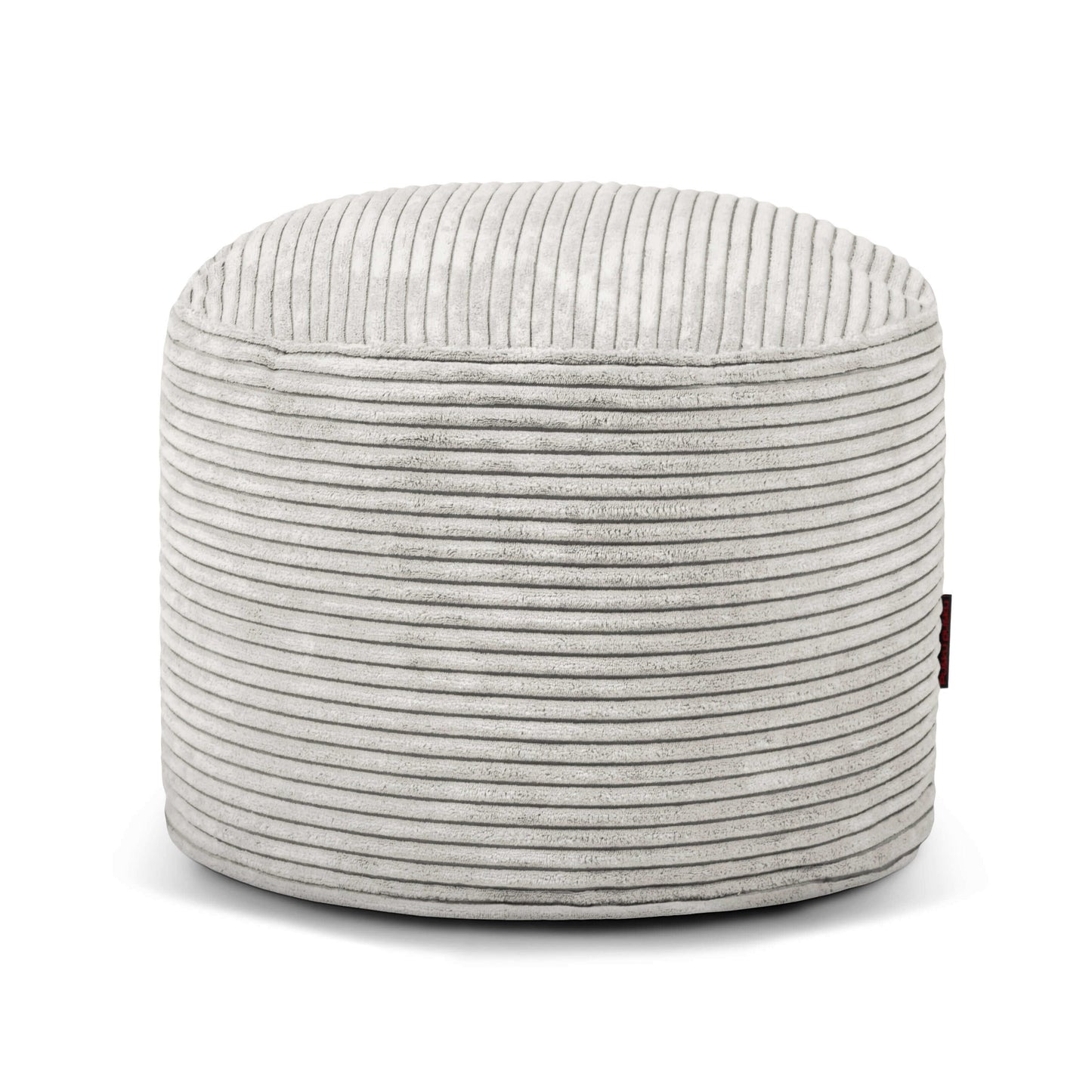 Una otomana MINI WAVES redonda y compacta de terciopelo acanalado (40×40×30 cm), mostrada de frente sobre un fondo blanco, ideal para el dormitorio o el salón.