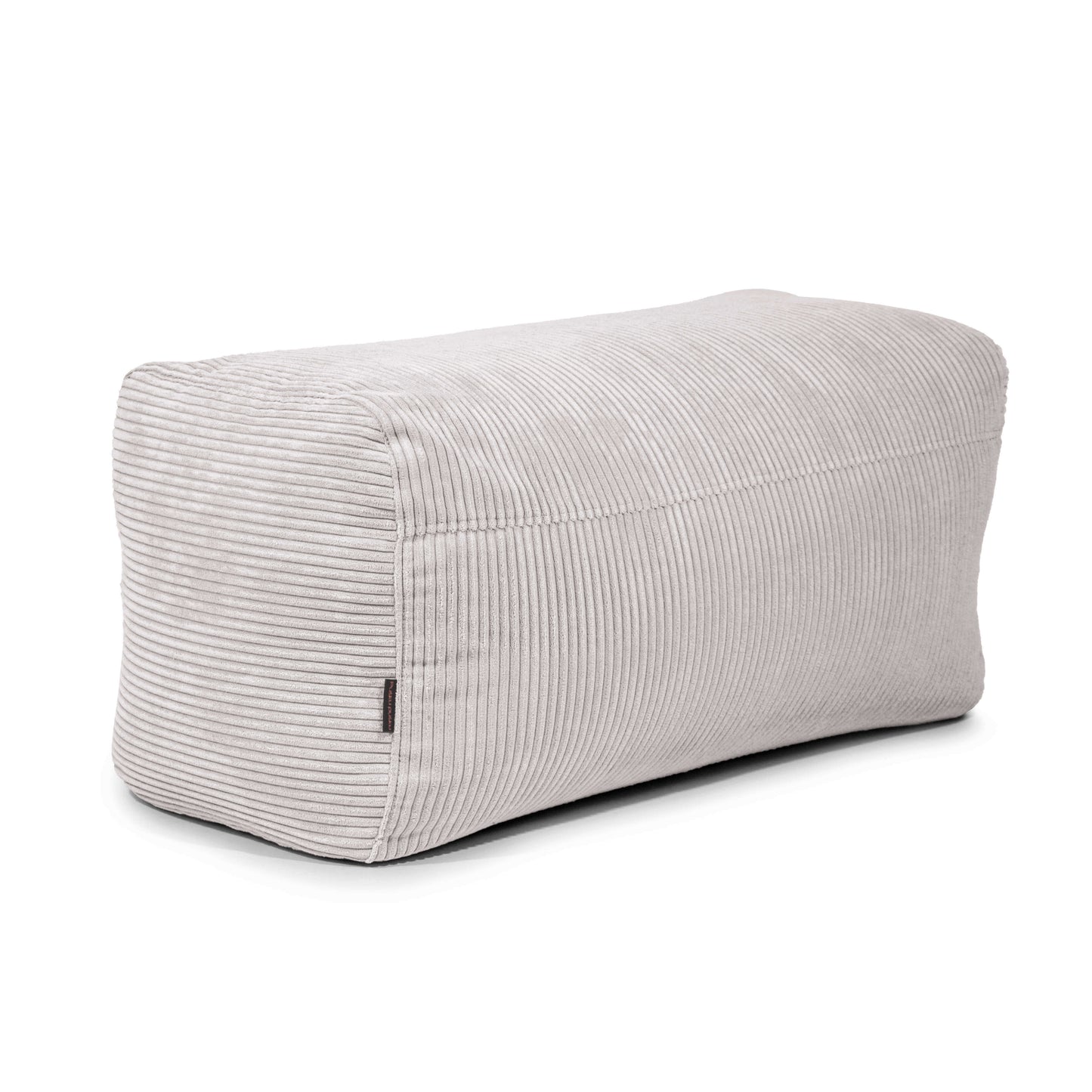 Pouf rectangular de terciopelo acanalado compacto y ligero 100×60×45 cm PLUS 100 WAVES en gris claro, con superficie texturizada y pequeña etiqueta lateral; ideal para el hogar, dormitorio o salón. Mostrado sobre fondo blanco.