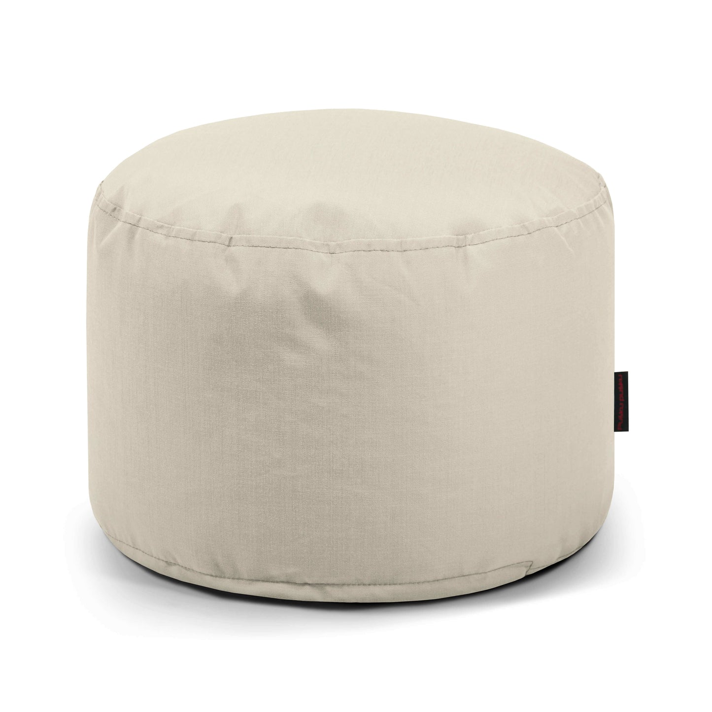 El Pouf Mini Colorin - uso exteriores es una otomana redonda de color beige con un suave tejido certificado OEKO-TEX y etiqueta lateral negra, que ofrece un asiento versátil y compacto ideal para cualquier entorno exterior.